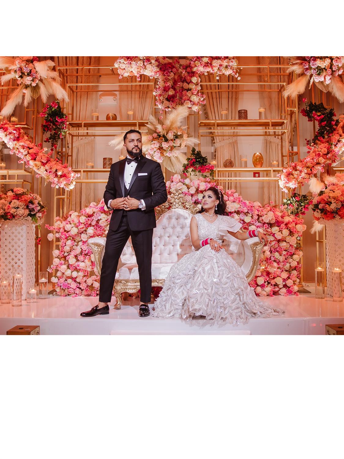 Couple by floral wall